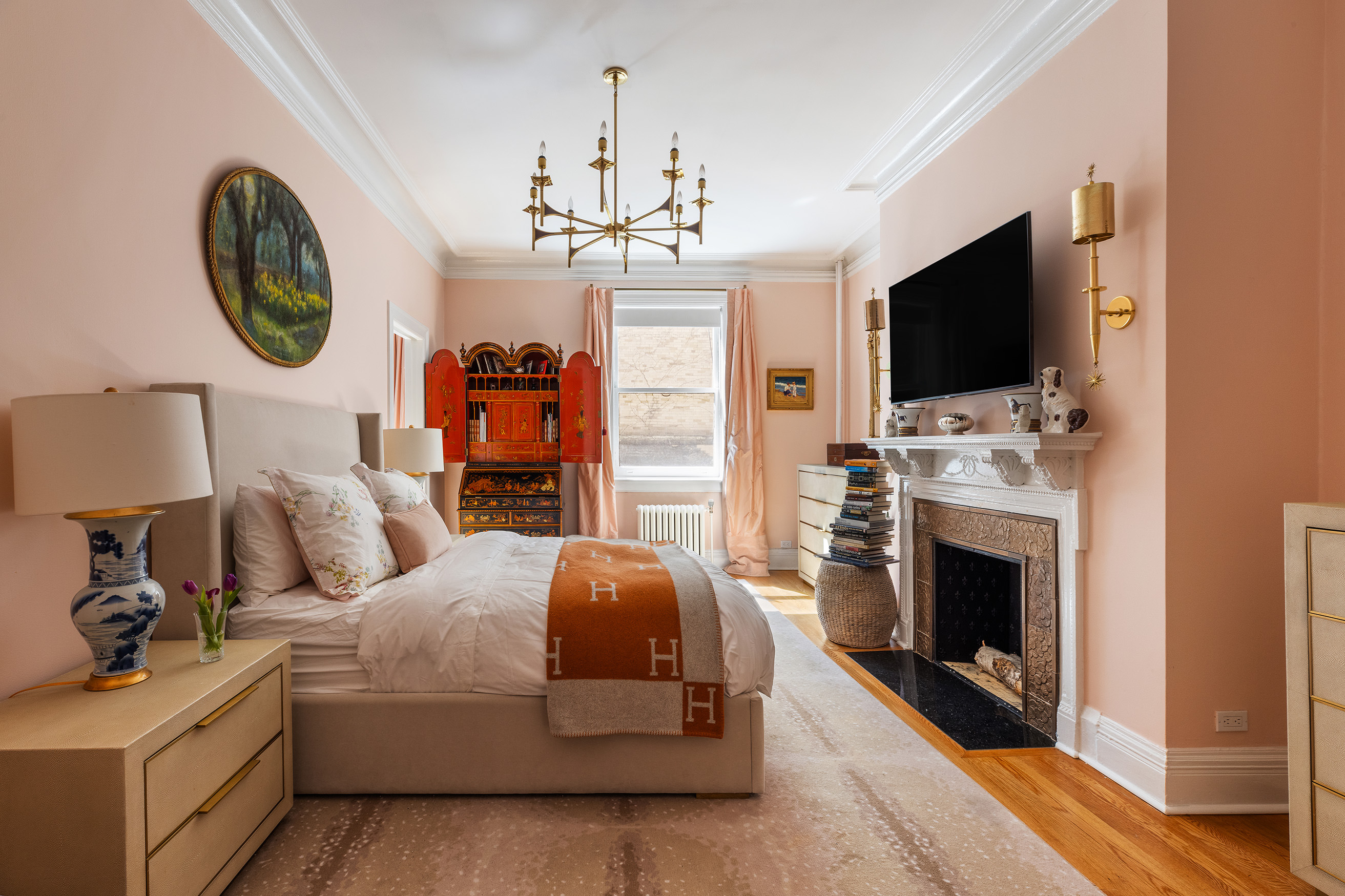 6 East 76th Street, Unit 3F Manhattan, NY 10021 - Photo 5 of 11 a living room with furniture a fireplace and a flat screen tv