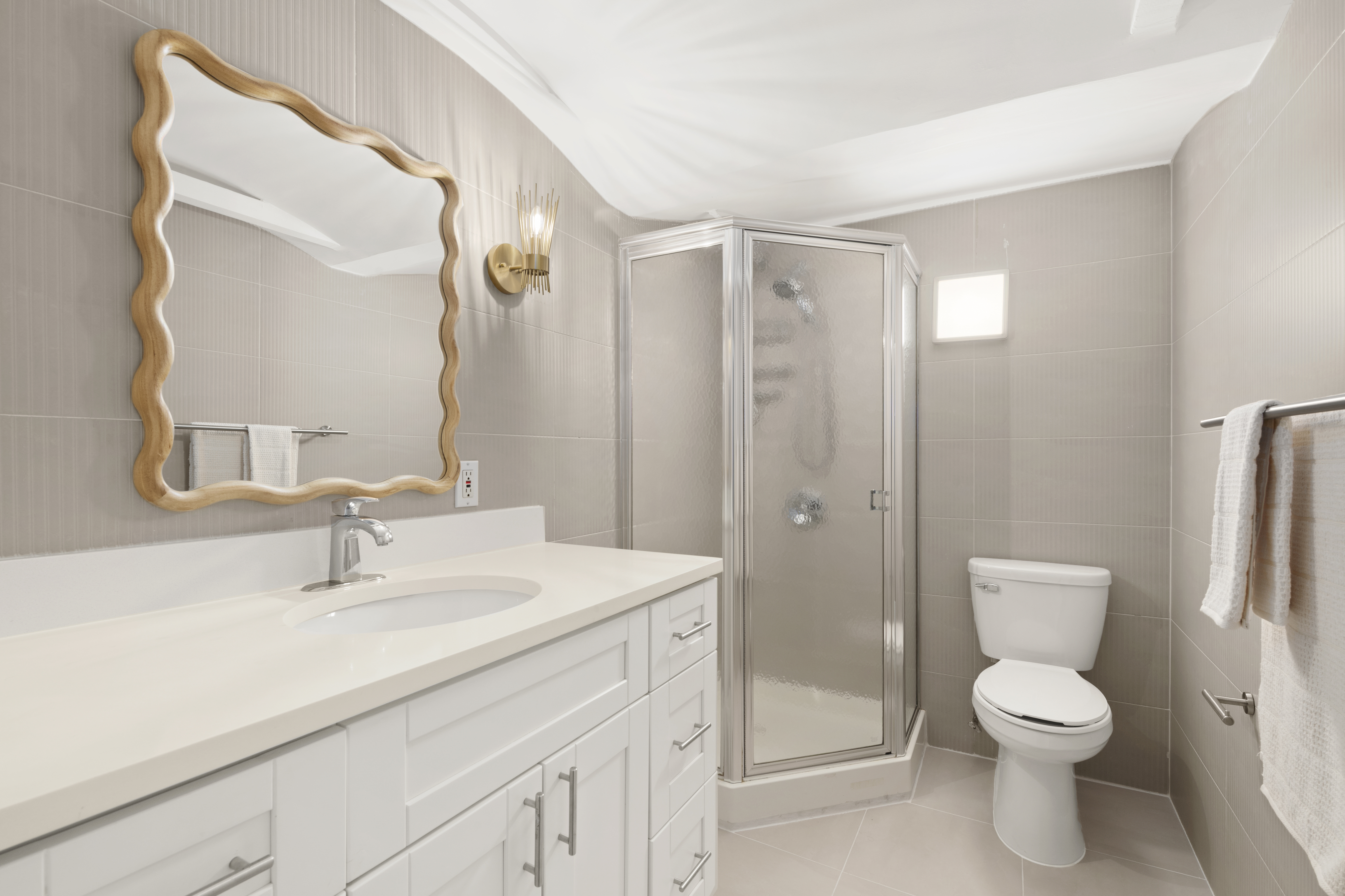 309 East 108th Street, Unit 2/D Manhattan, NY 10029 - Photo 10 of 12 a bathroom with a toilet a sink and a mirror