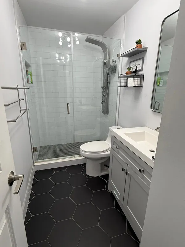 a bathroom with a double vanity sink mirror and toilet