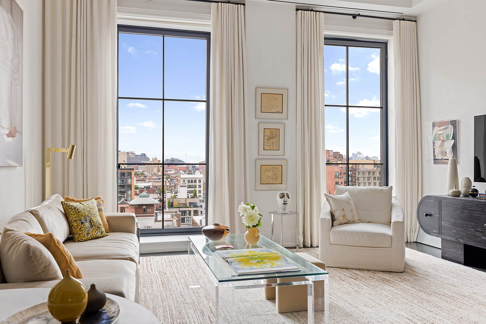 212 West 18th Street, Unit 9C Manhattan, NY 10011 - Photo 3 of 10 a living room with furniture and a large window