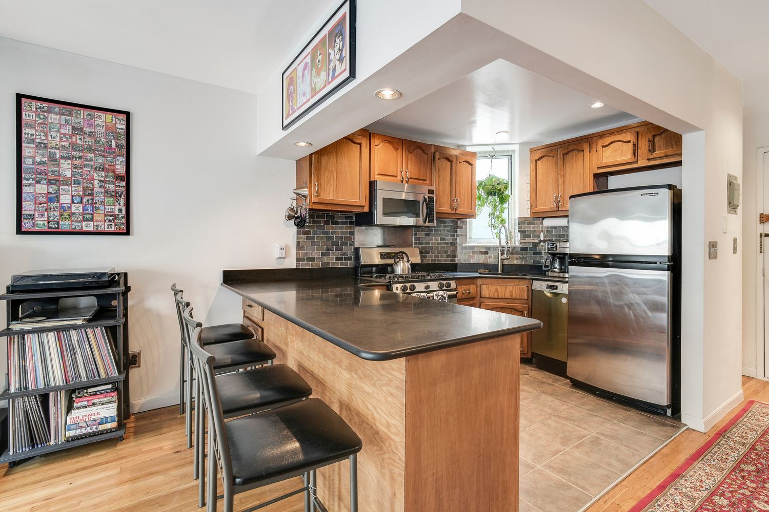 a kitchen with kitchen island a counter top space a sink and a refrigerator