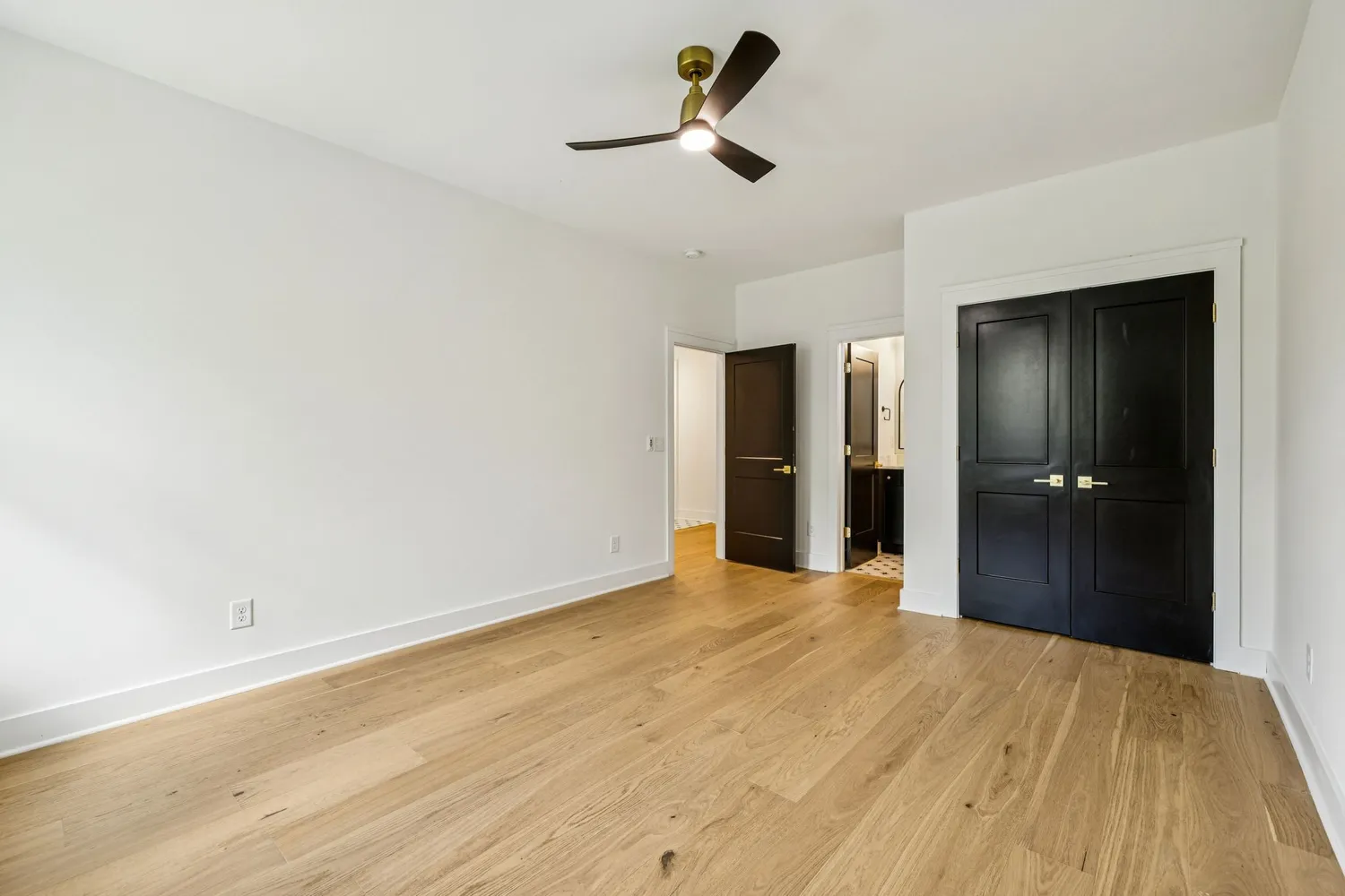 a view of empty room with wooden floor