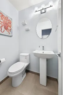 a bathroom with a toilet sink and mirror