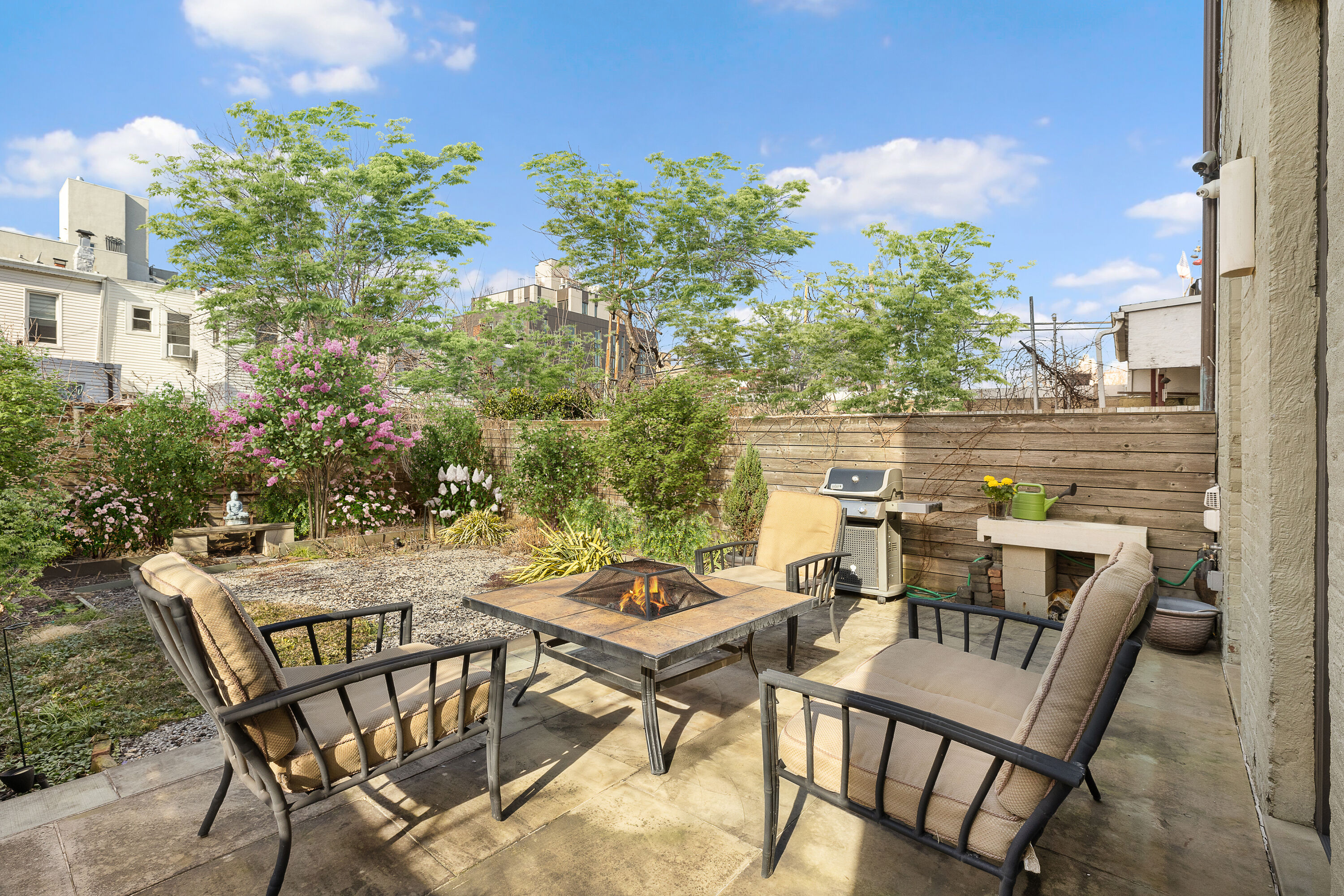 38-06 28th Street, Unit 1 Queens, NY 11101 - Photo 1 of 8 a view of a patio with table and chairs and potted plants