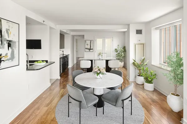 a view of a dining room with furniture and wooden floor