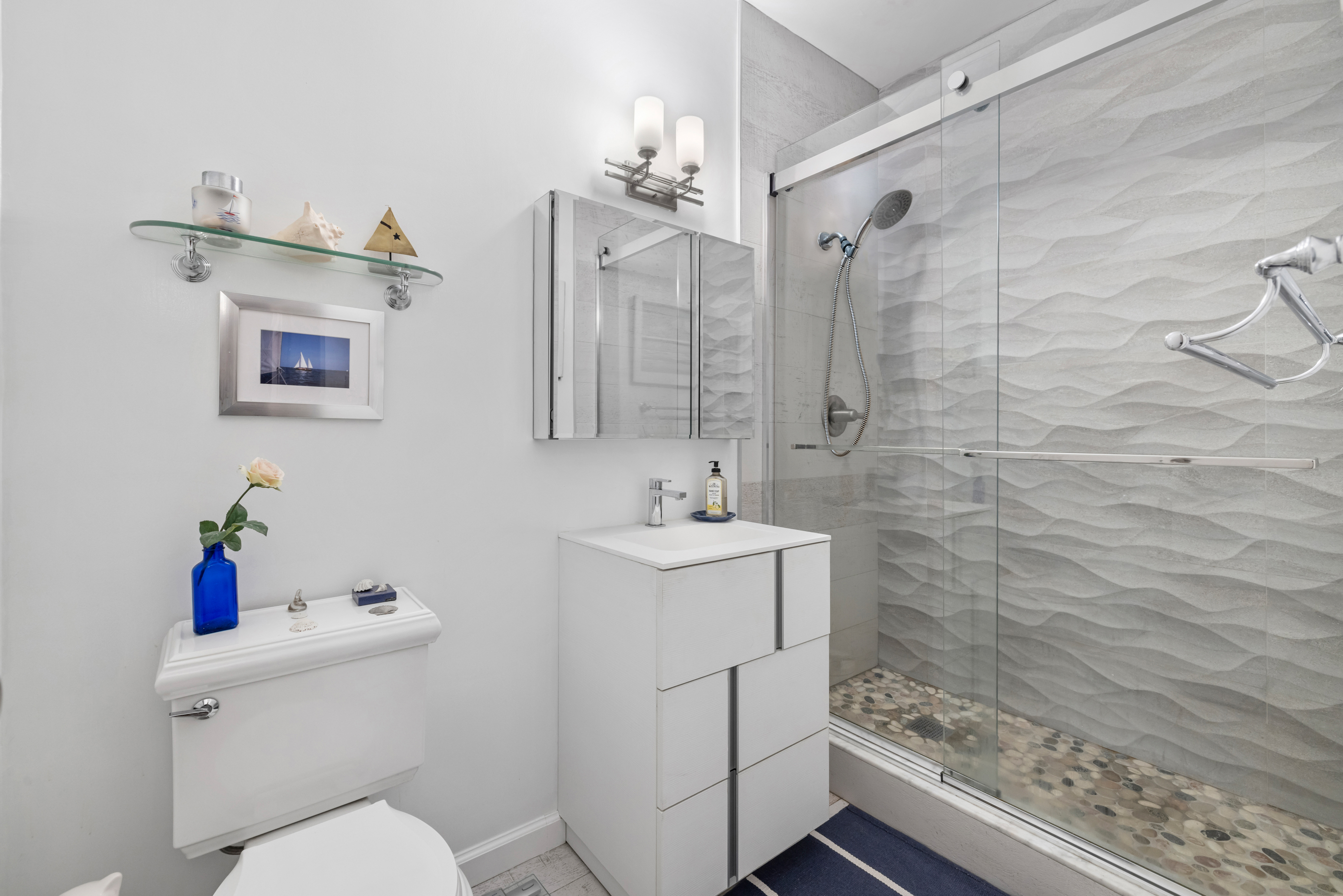 166 Bank Street, Unit LOFT2C Manhattan, NY 10014 - Photo 9 of 11 a bathroom with a sink a toilet and shower