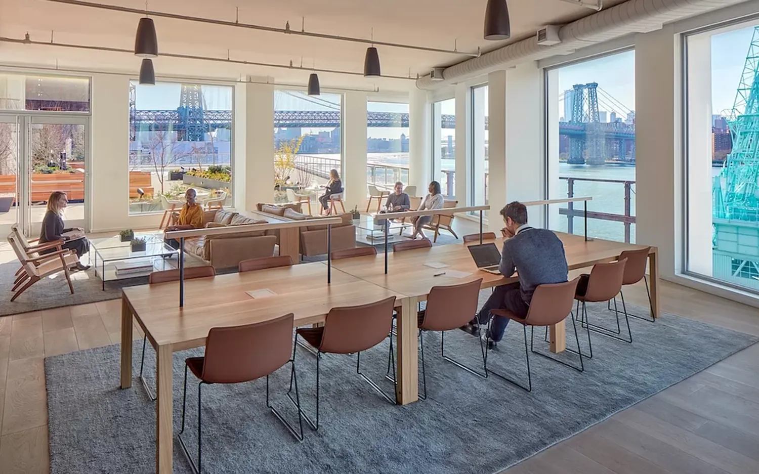 a living room with furniture and floor to ceiling windows