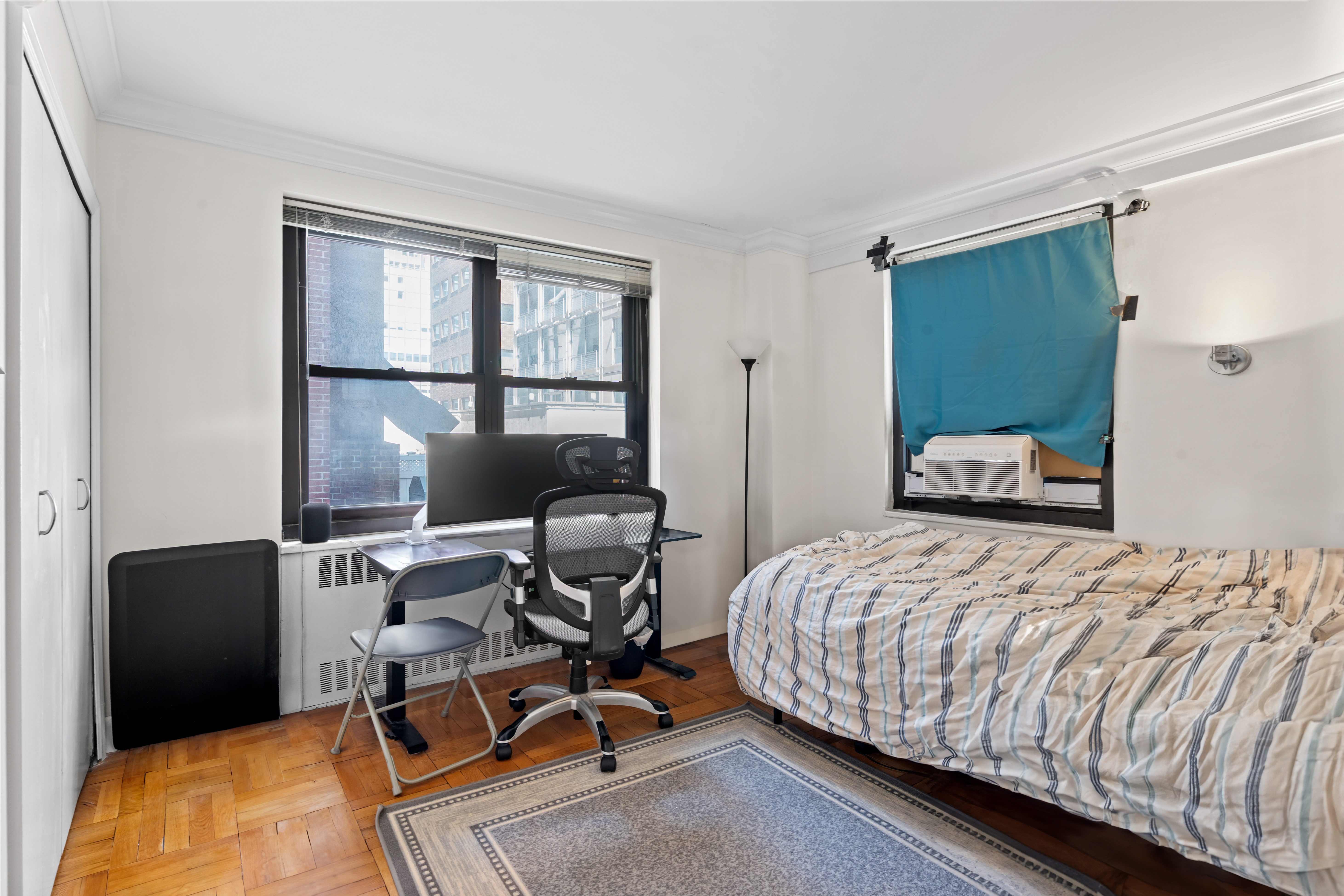 135 East 54th Street, Unit 3H Manhattan, NY 10022 - Photo 5 of 7 a bedroom with a bed and a window