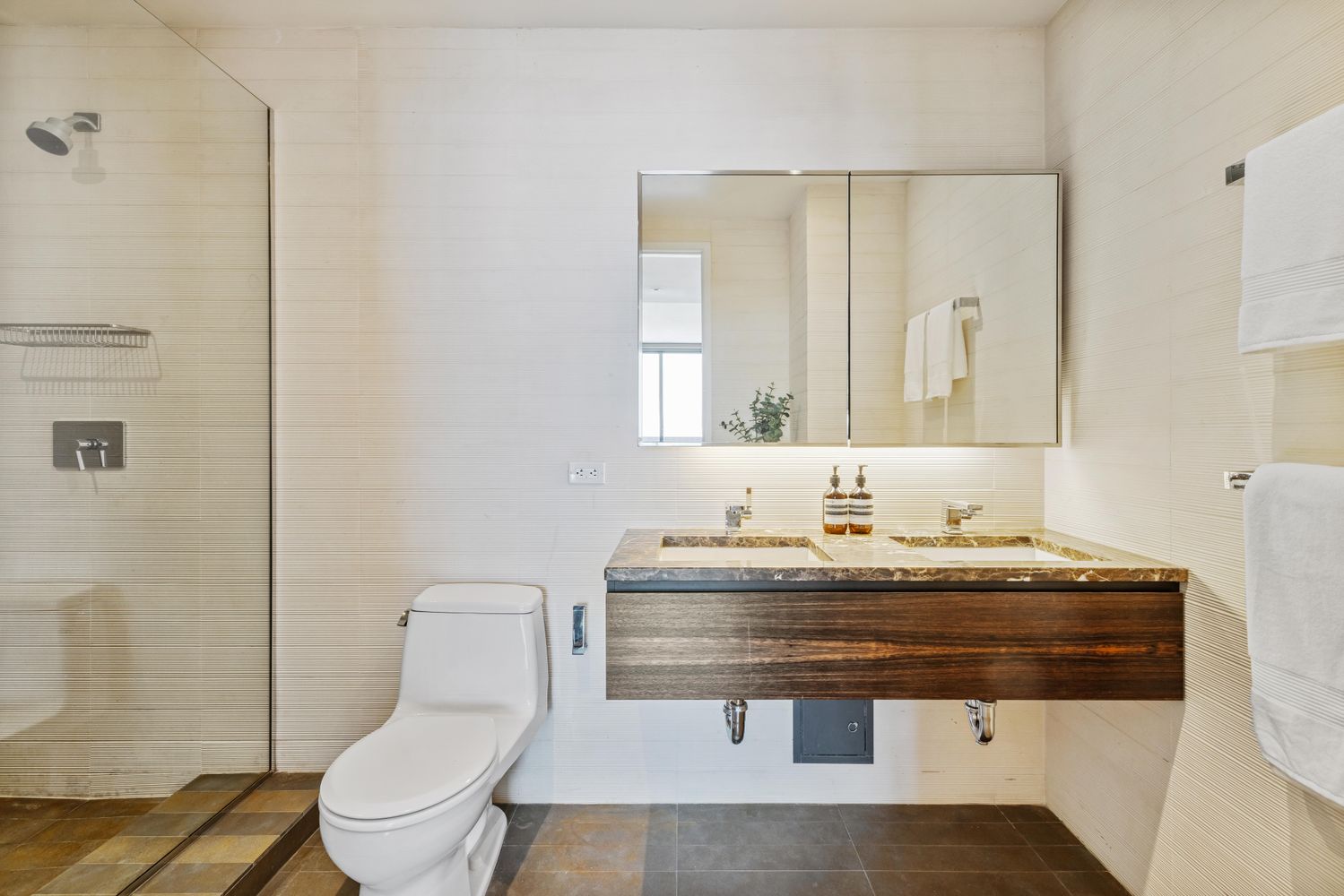 a bathroom with a sink toilet and mirror