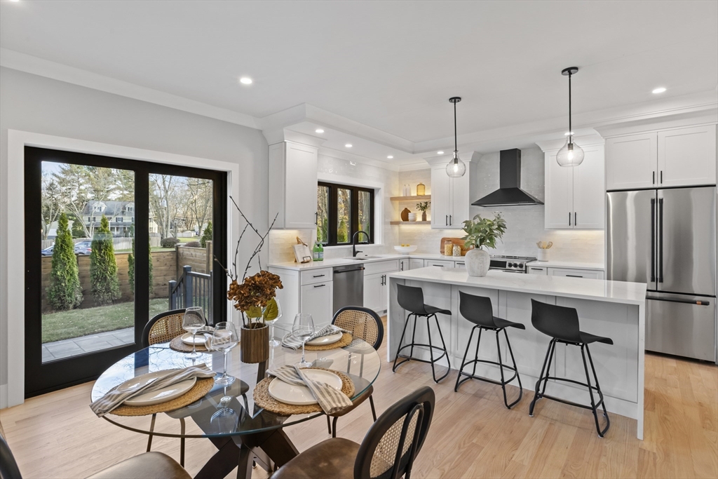 10 Webber Avenue, Unit 3C Bedford, MA 01730 - Photo 4 of 36 a dining room with furniture a chandelier and wooden floor
