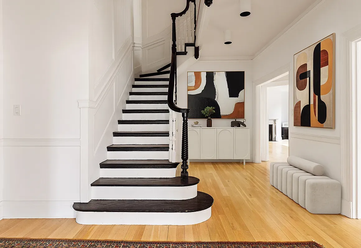 a view of entryway and hall with wooden floor