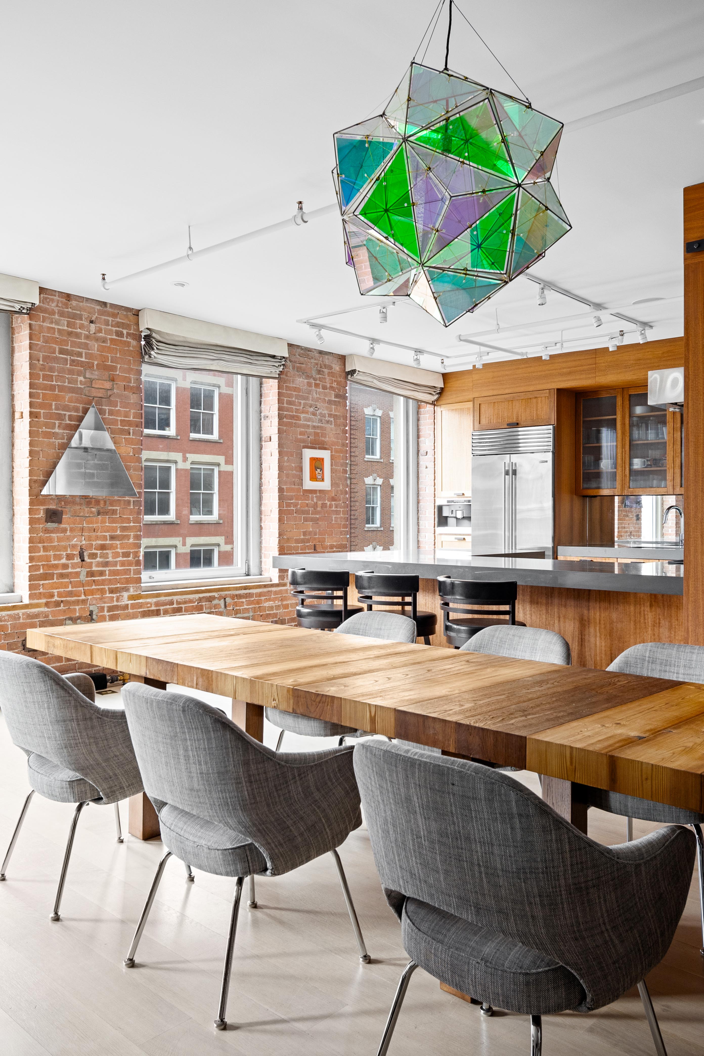 420 West Broadway, Unit 4W Manhattan, NY 10012 - Photo 6 of 17 a view of a kitchen with a table and chairs