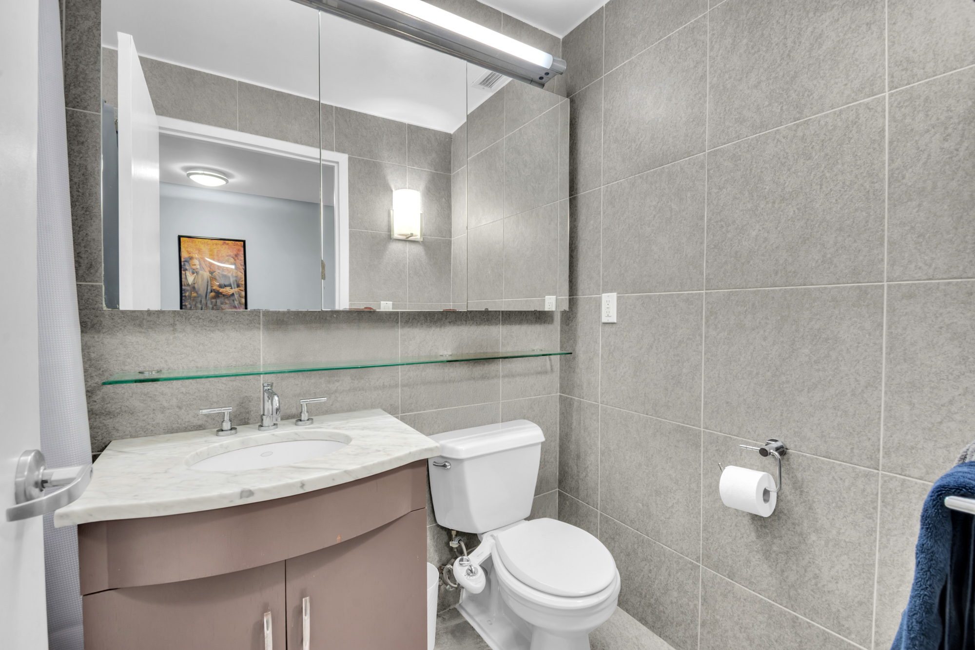 80 John Street, Unit 14D Manhattan, NY 10038 - Photo 8 of 8 a bathroom with a sink toilet and mirror