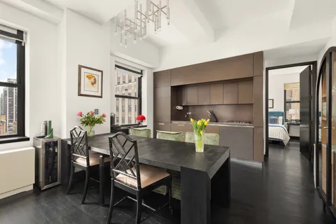a dining room with furniture and wooden floor