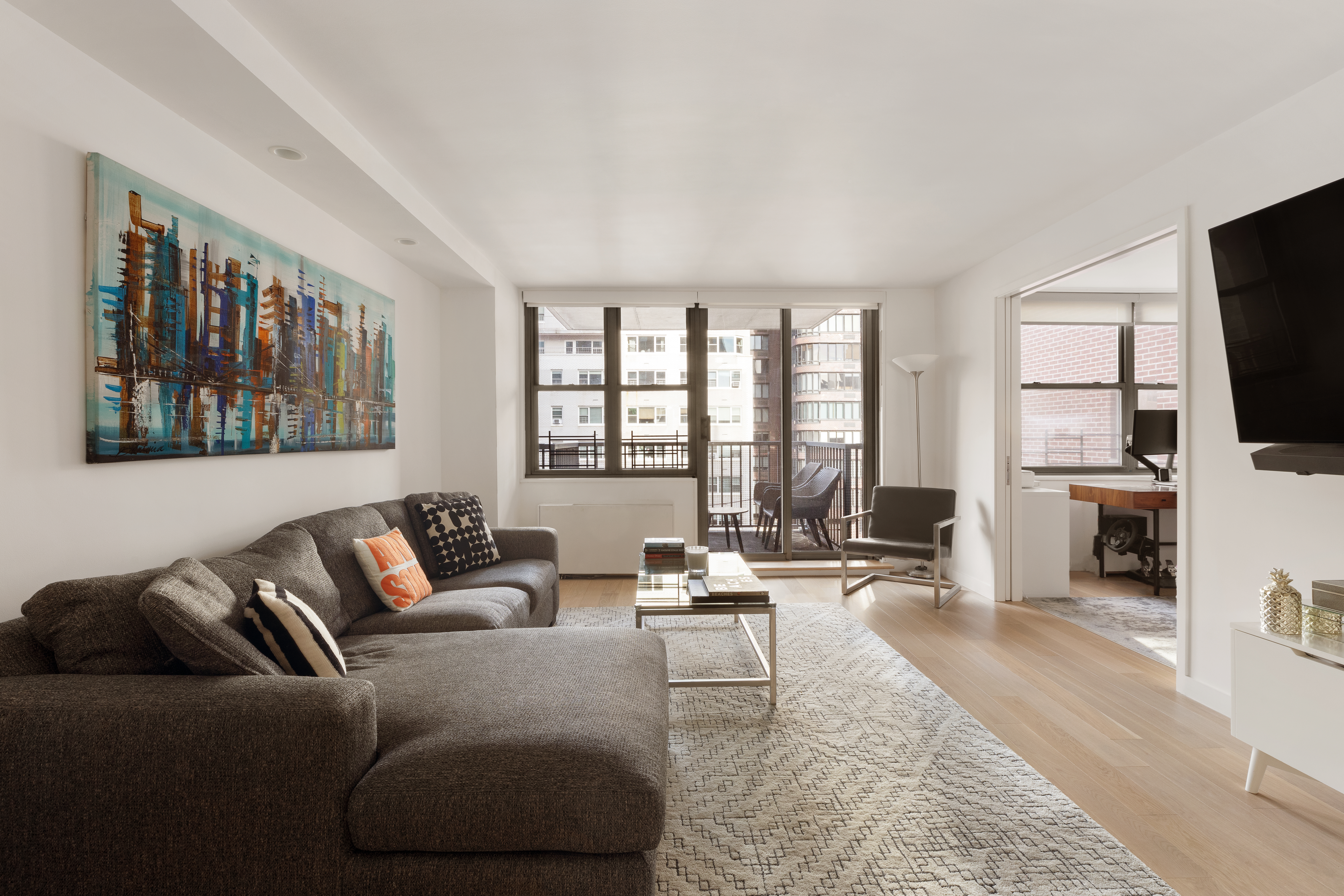 444 East 86th Street, Unit 12G Manhattan, NY 10028 - Photo 1 of 11 a living room with furniture and a flat screen tv