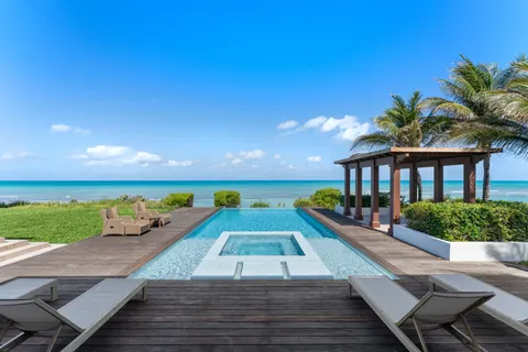 swimming pool view with a seating space