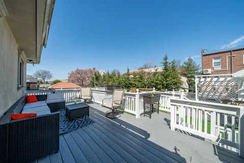 a balcony with furniture and wooden floor