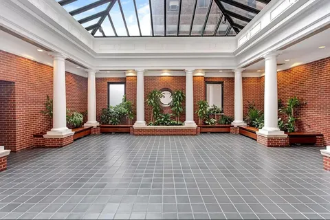 a living room with furniture and floor to ceiling windows