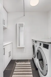 a view of a hallway with washer and dryer