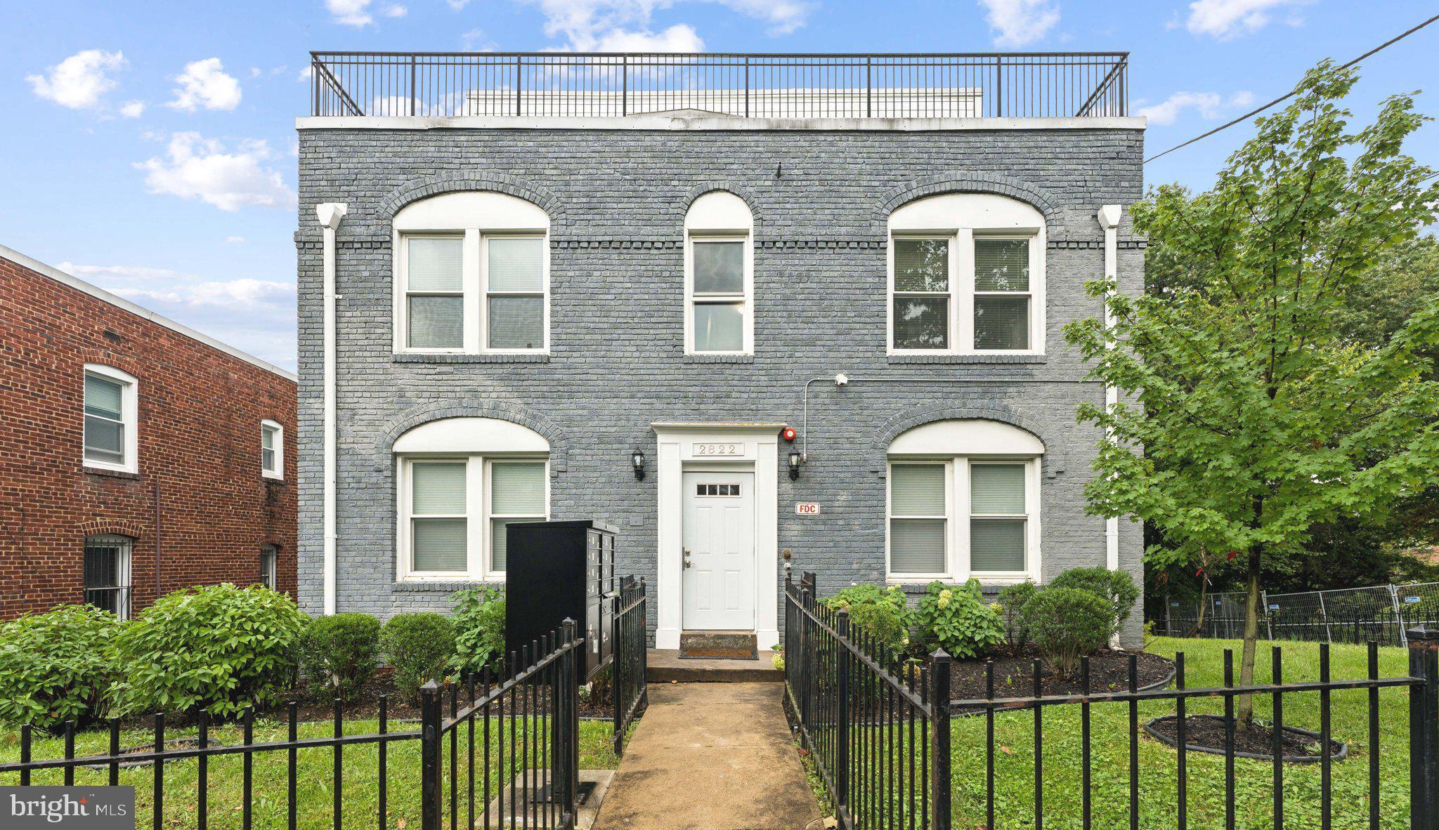 2822 28th Street Southeast Washington, DC 20020 - Photo 1 of 57 a front view of a house with a garden