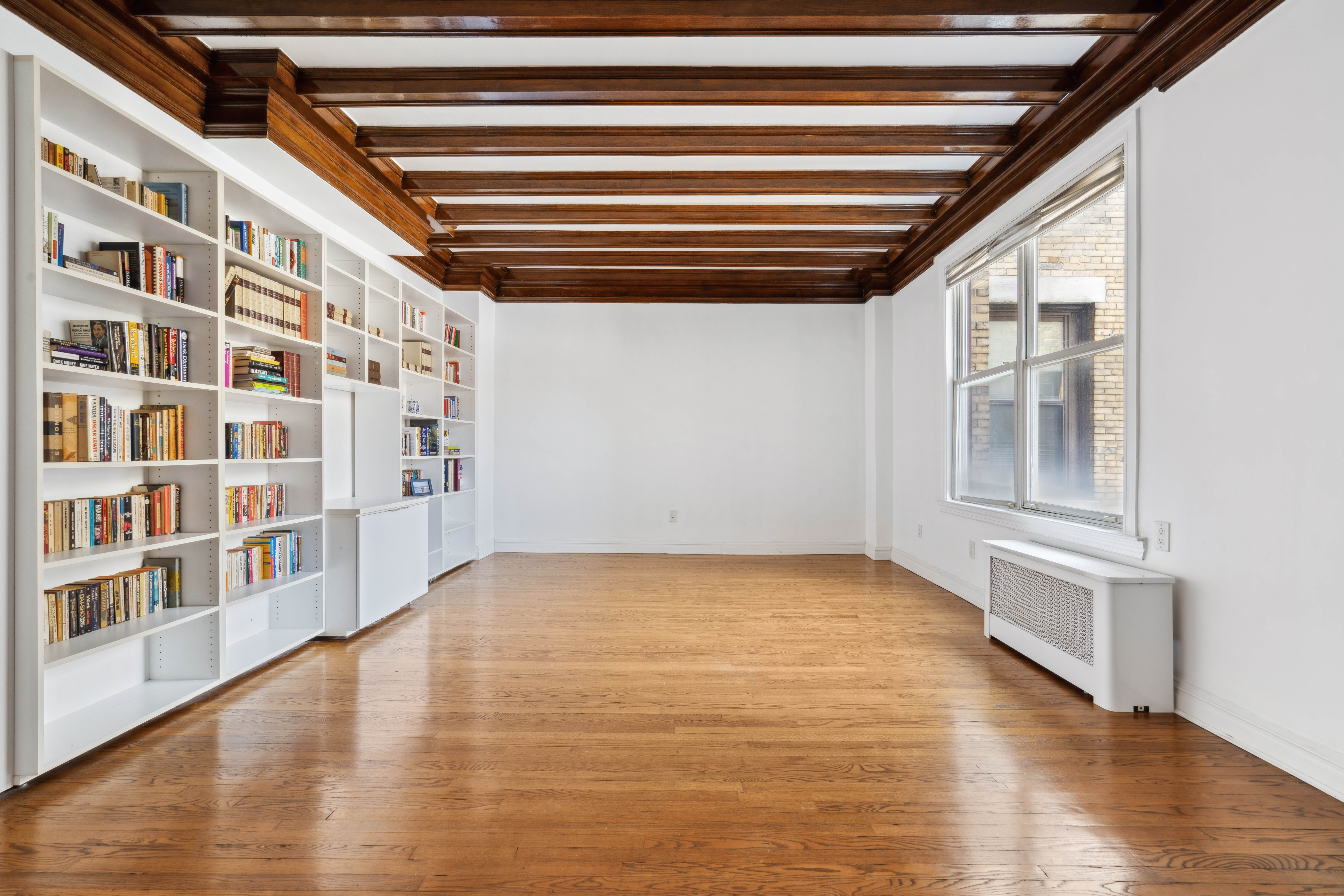 380 Riverside Drive, Unit 7B Manhattan, NY 10025 - Photo 2 of 12 a view of an empty room with wooden floor and a window