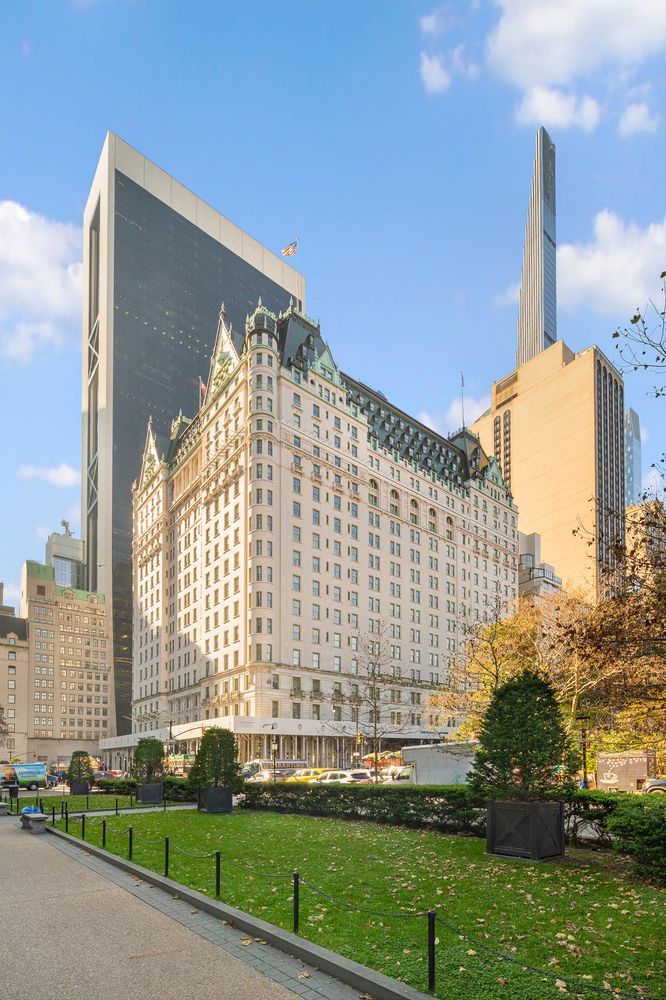 1 Central Park South, Unit 1126 Manhattan, NY 10019 - Photo 17 of 19 a front view of a residential apartment building with a yard