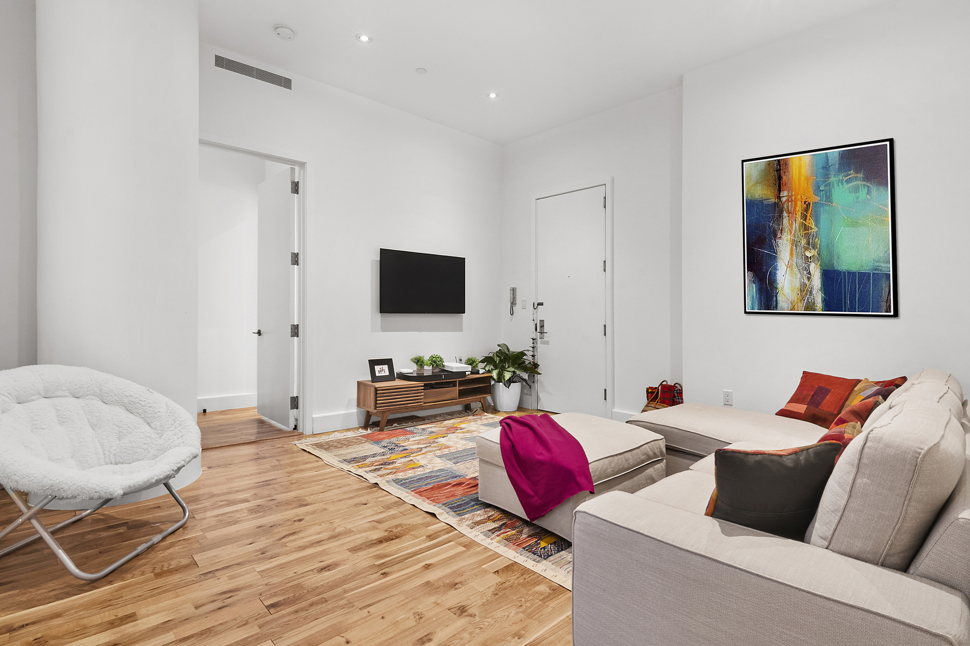 360 Furman Street, Unit 320/321 Brooklyn, NY 11201 - Photo 12 of 28 a living room with furniture and a flat screen tv
