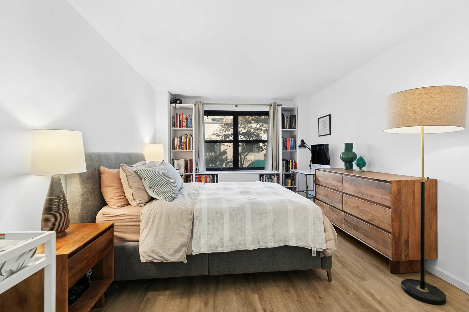 a bedroom with a large bed and a window