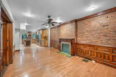 a view of a kitchen with a sink and a fireplace