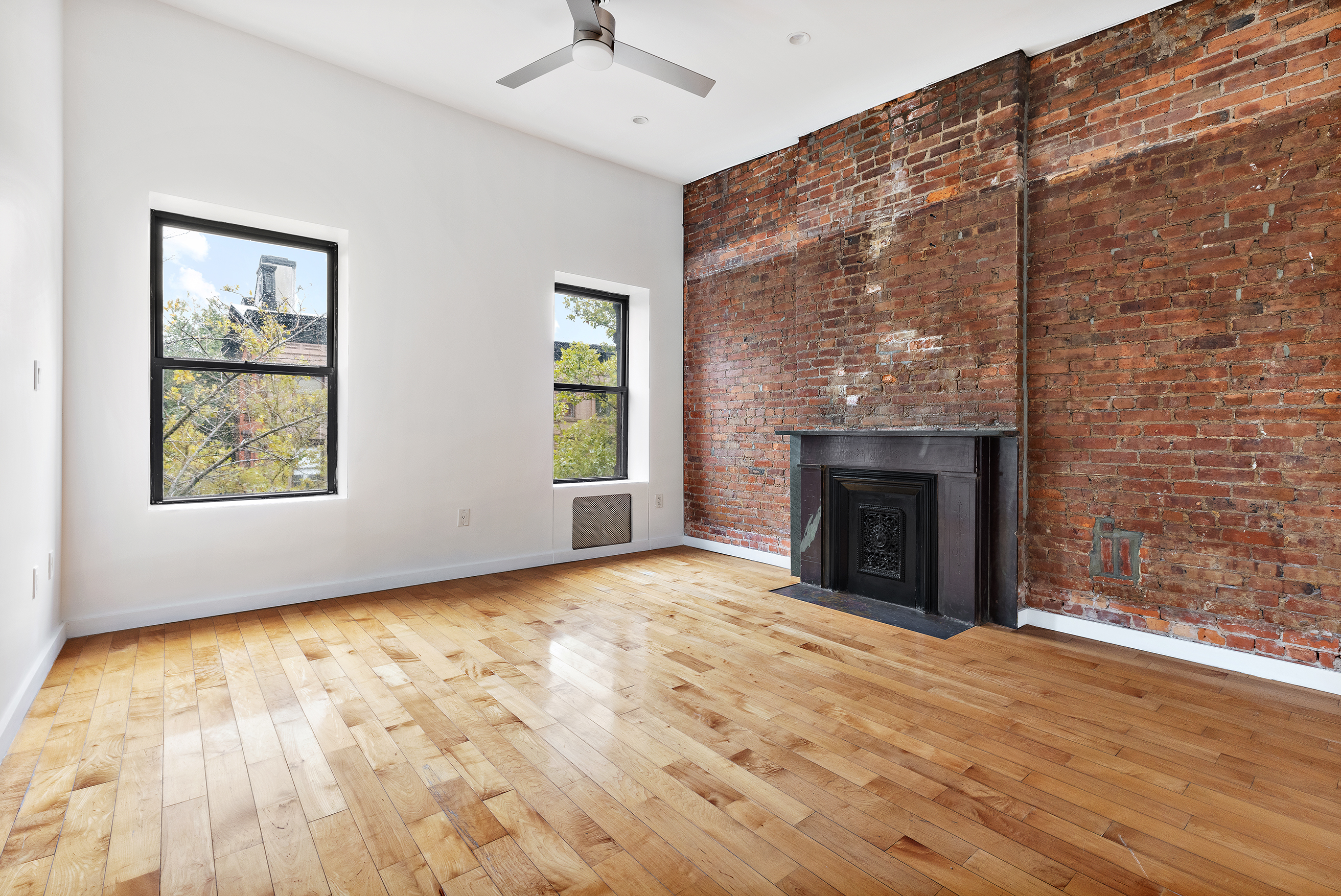 2 South Oxford Street, Unit 1 Brooklyn, NY 11217 - Photo 5 of 8 an empty room with windows and fireplace
