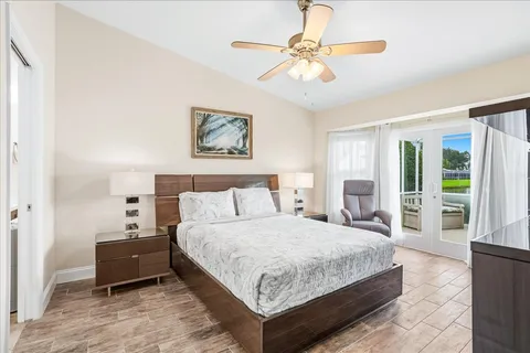 a bedroom with a bed and a chandelier