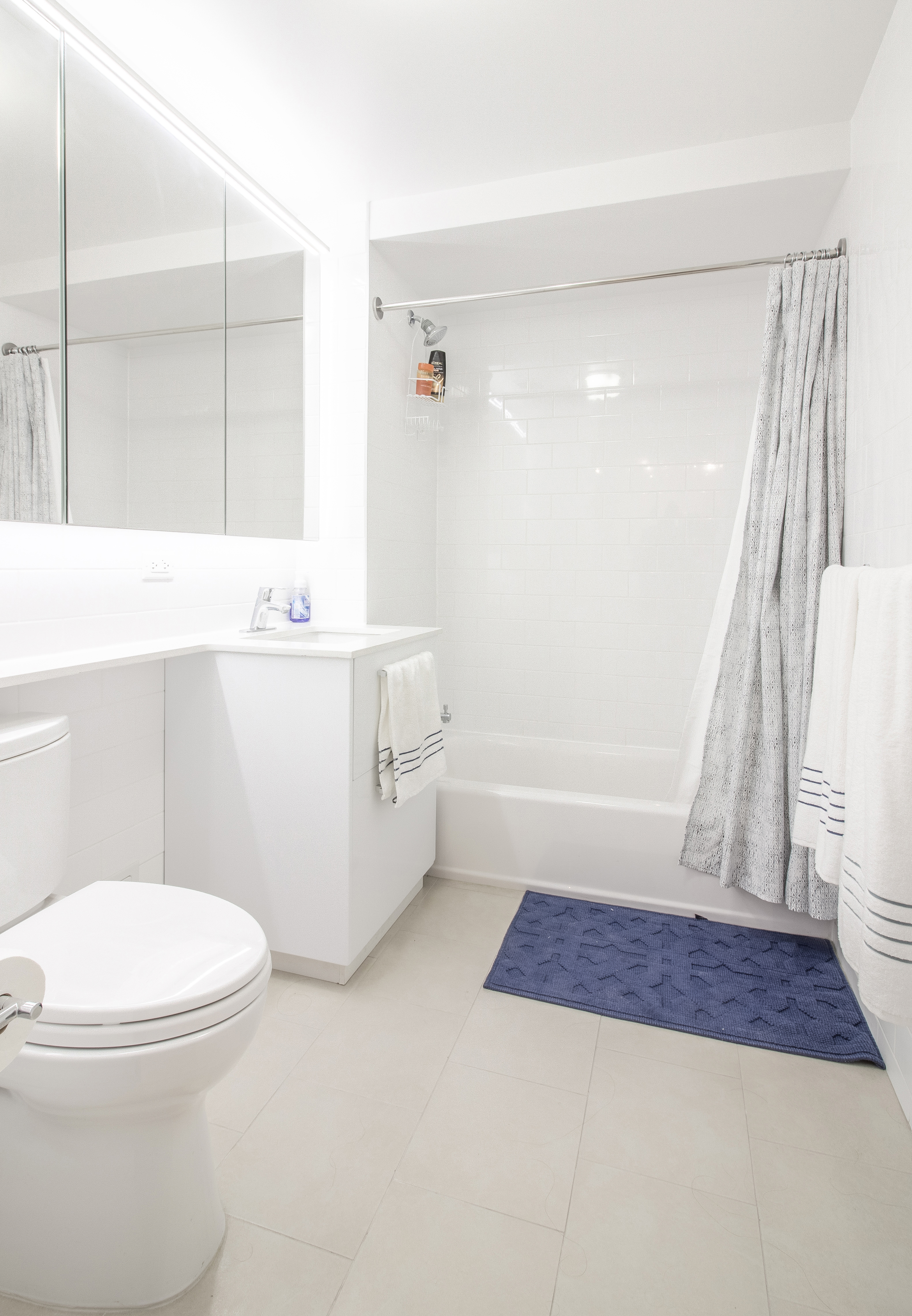 51 East 131st Street, Unit 6A Manhattan, NY 10037 - Photo 8 of 12 a bathroom with a sink a toilet a mirror and shower