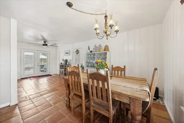 a view of a dining room with furniture and chandelier