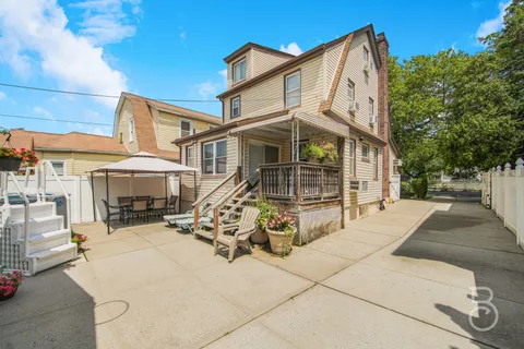 a view of a house with backyard porch and sitting area