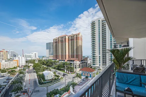 a balcony with outdoor seating and plants