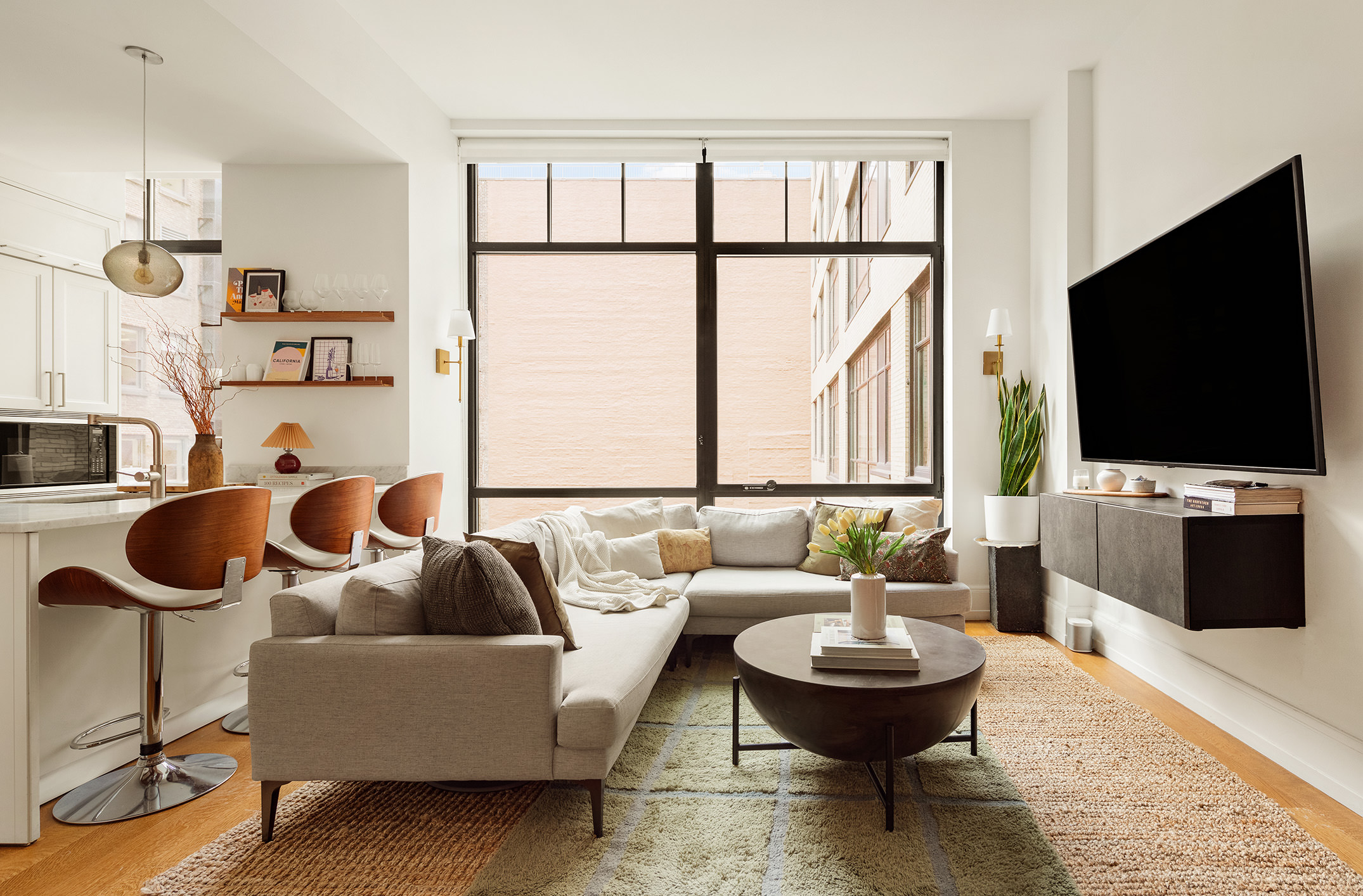a living room with couches and a flat screen tv