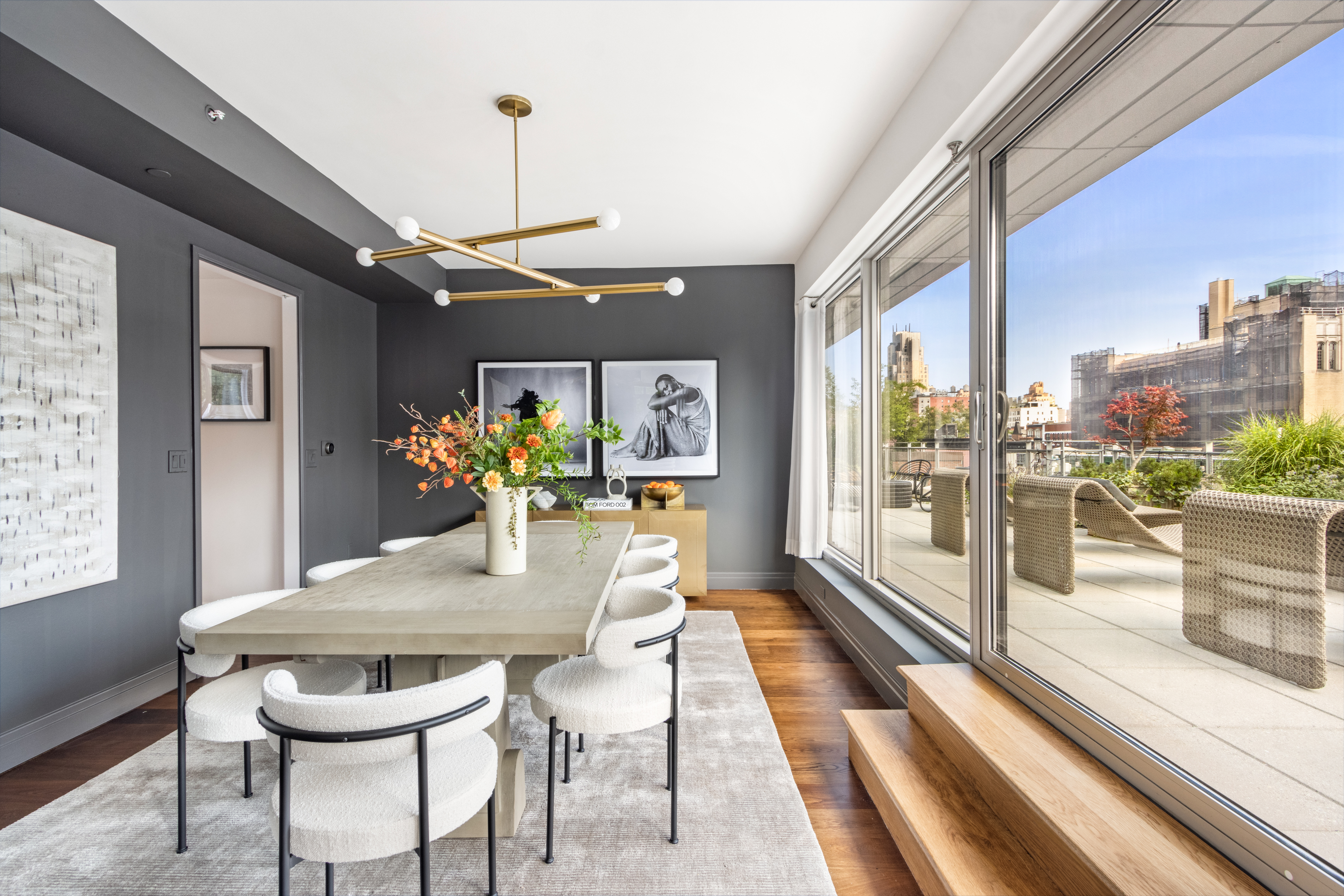 177 9th Avenue, Unit PHA Manhattan, NY 10011 - Photo 3 of 28 a dining room with furniture a chandelier and wooden floor