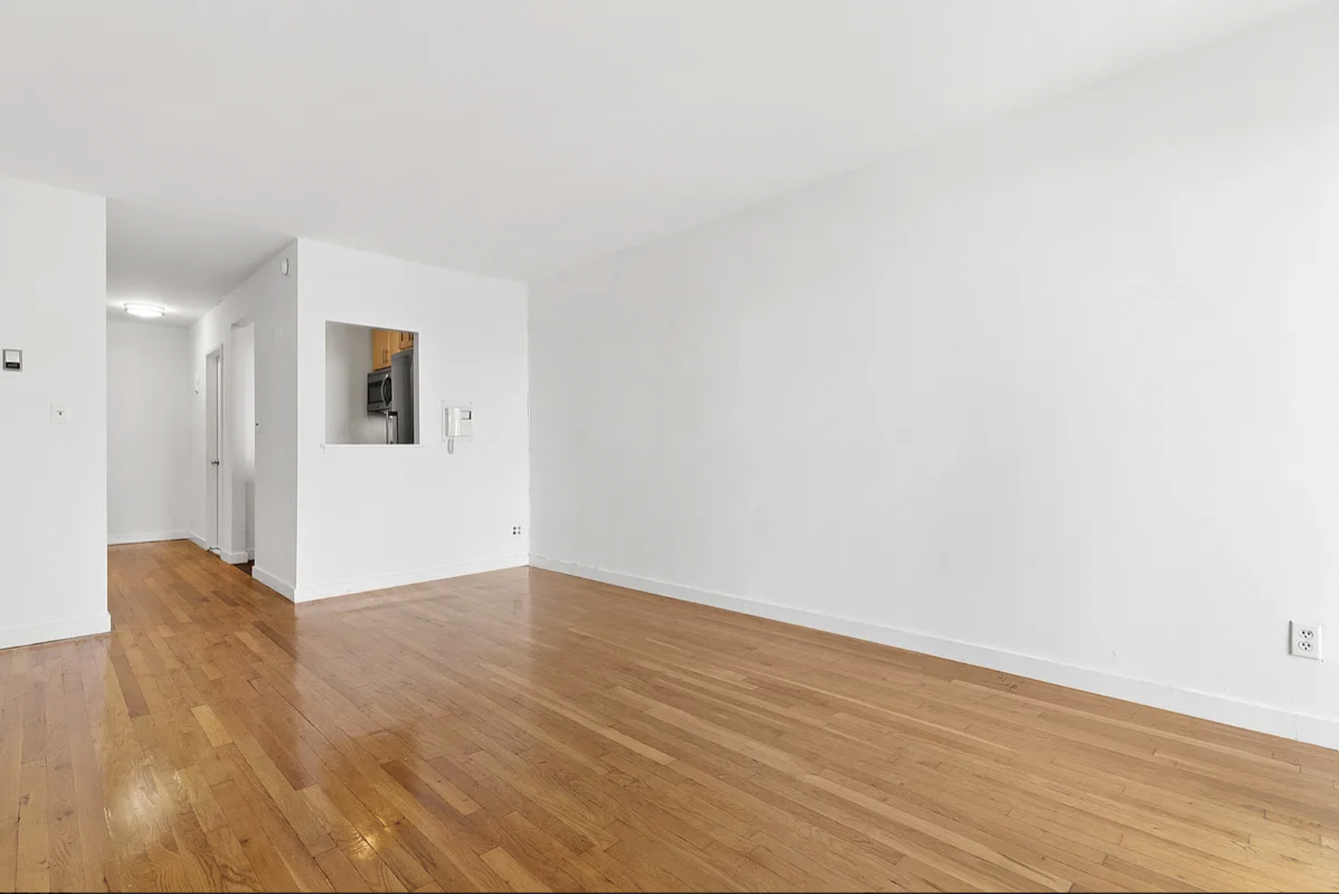 343 East 76th Street, Unit 1B Manhattan, NY 10021 - Photo 2 of 5 a view of an empty room with wooden floor