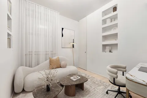 a bedroom with a bed and a chair