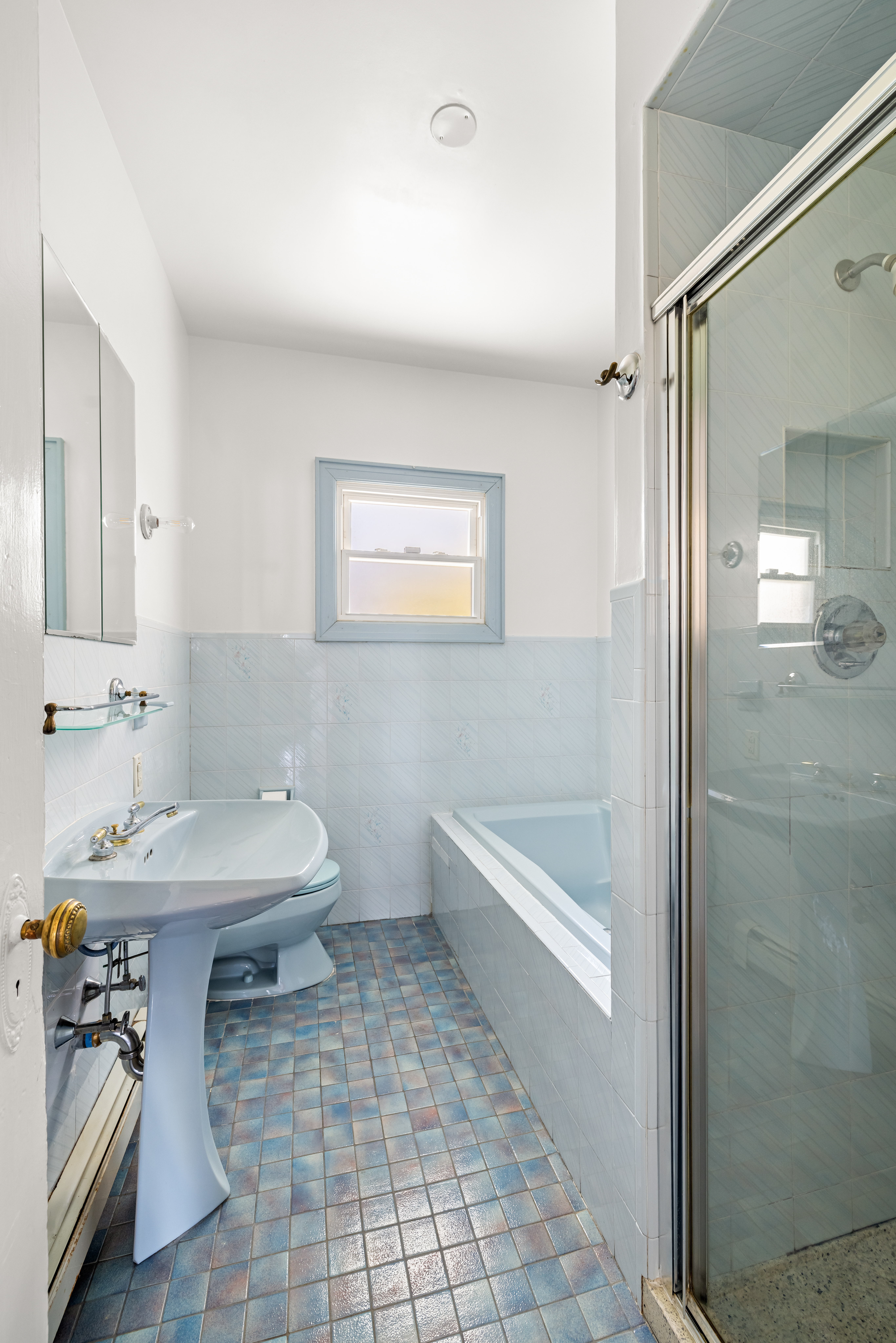 792 East 21st Street Brooklyn, NY 11210 - Photo 14 of 29 a bathroom with a sink a toilet and shower