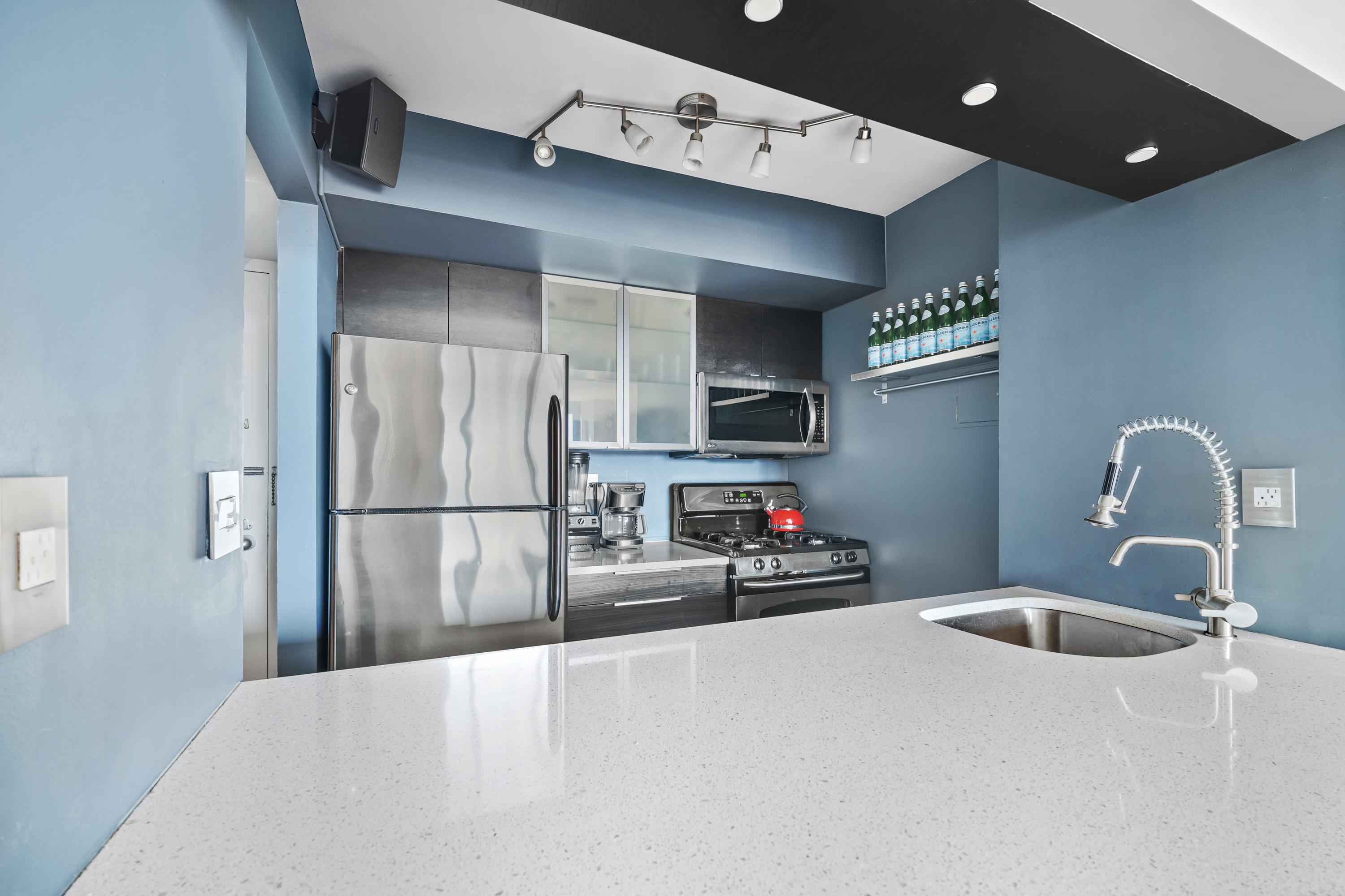 1 Irving Place, Unit U21E Manhattan, NY 10003 - Photo 6 of 9 a kitchen with refrigerator a sink a stove and cabinets