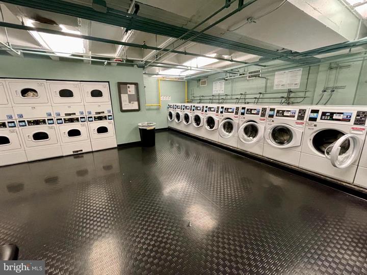 1101 3rd Street Southwest, Unit 206 Washington, DC 20024 - Photo 9 of 21 a utility room with stainless steel appliances kitchen island granite countertop a stove and a more cabinets