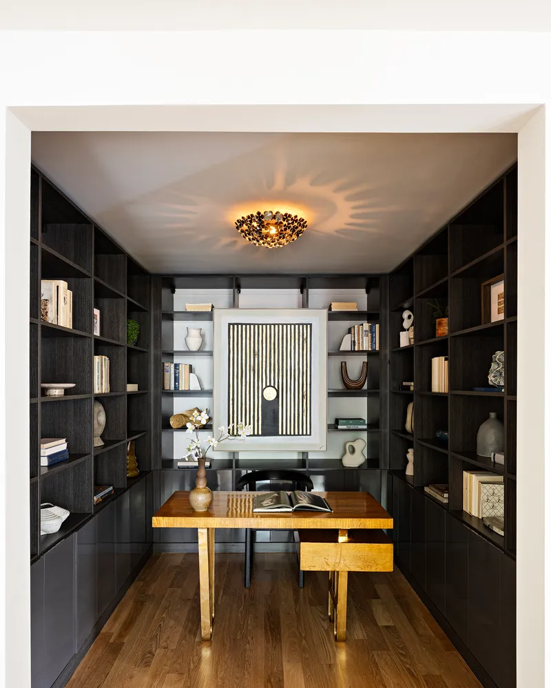 a living room with furniture a rug and a book shelf