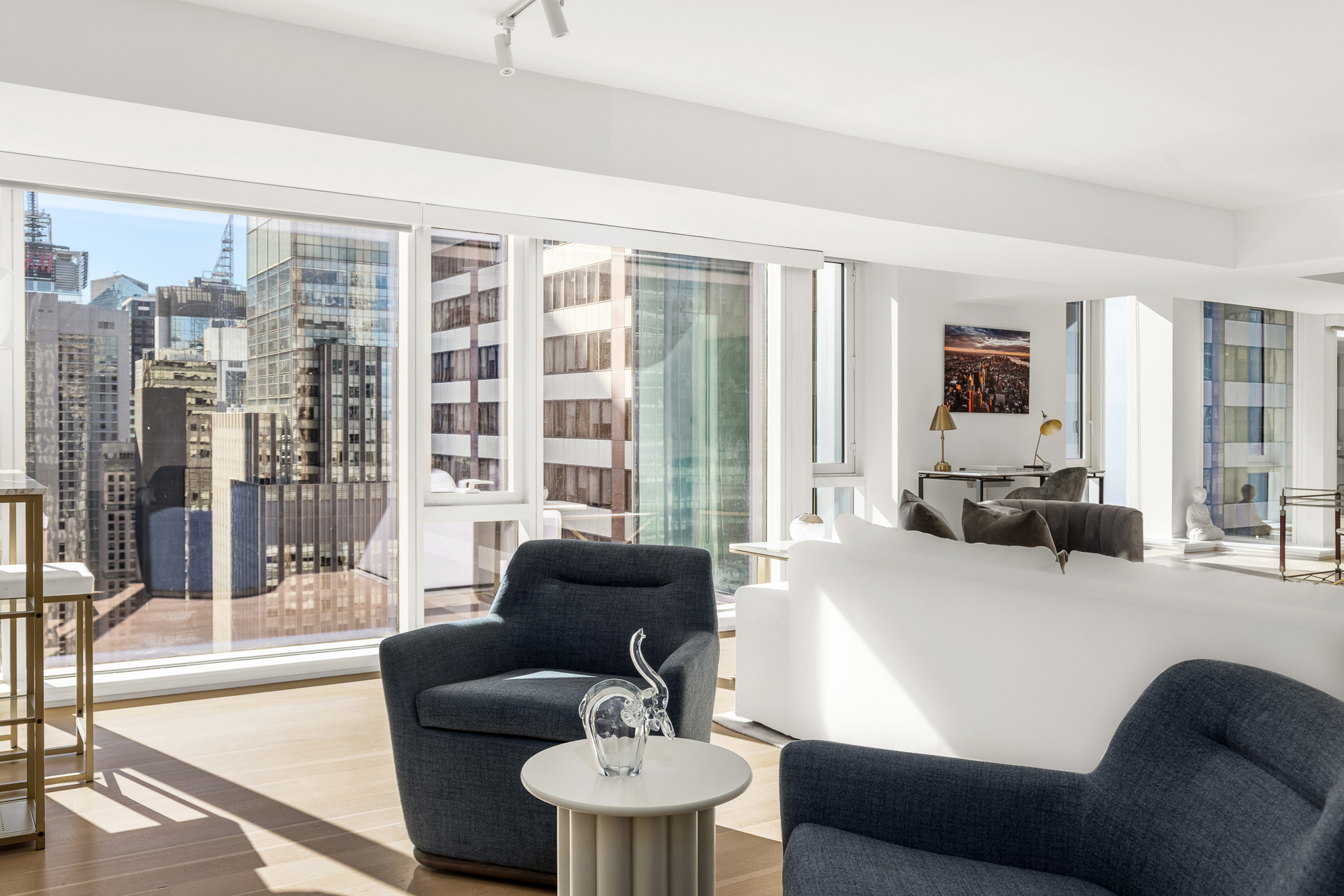 135 West 52nd Street, Unit 40A Manhattan, NY 10019 - Photo 3 of 24 a living room with furniture and a large window