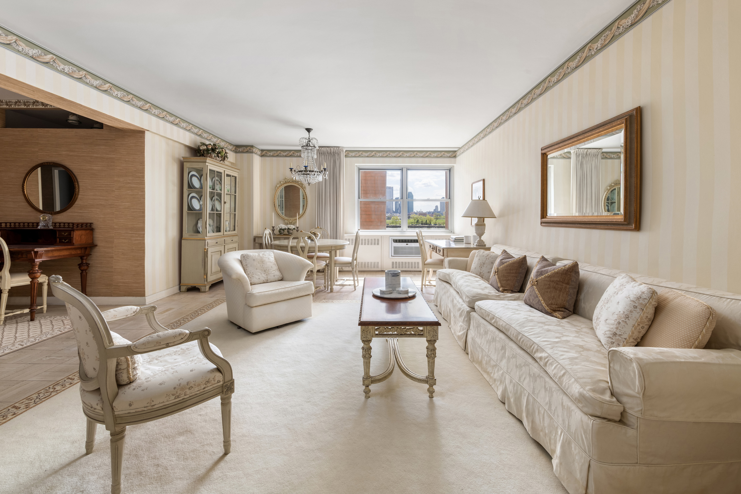 25 Sutton Place South, Unit 4I Manhattan, NY 10022 - Photo 3 of 16 a living room with furniture and a large window