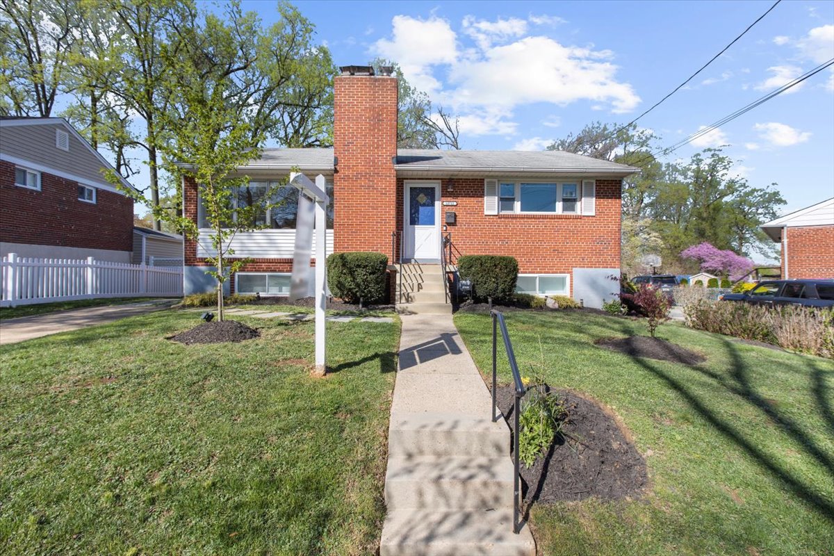 a view of a house with a yard and a garden