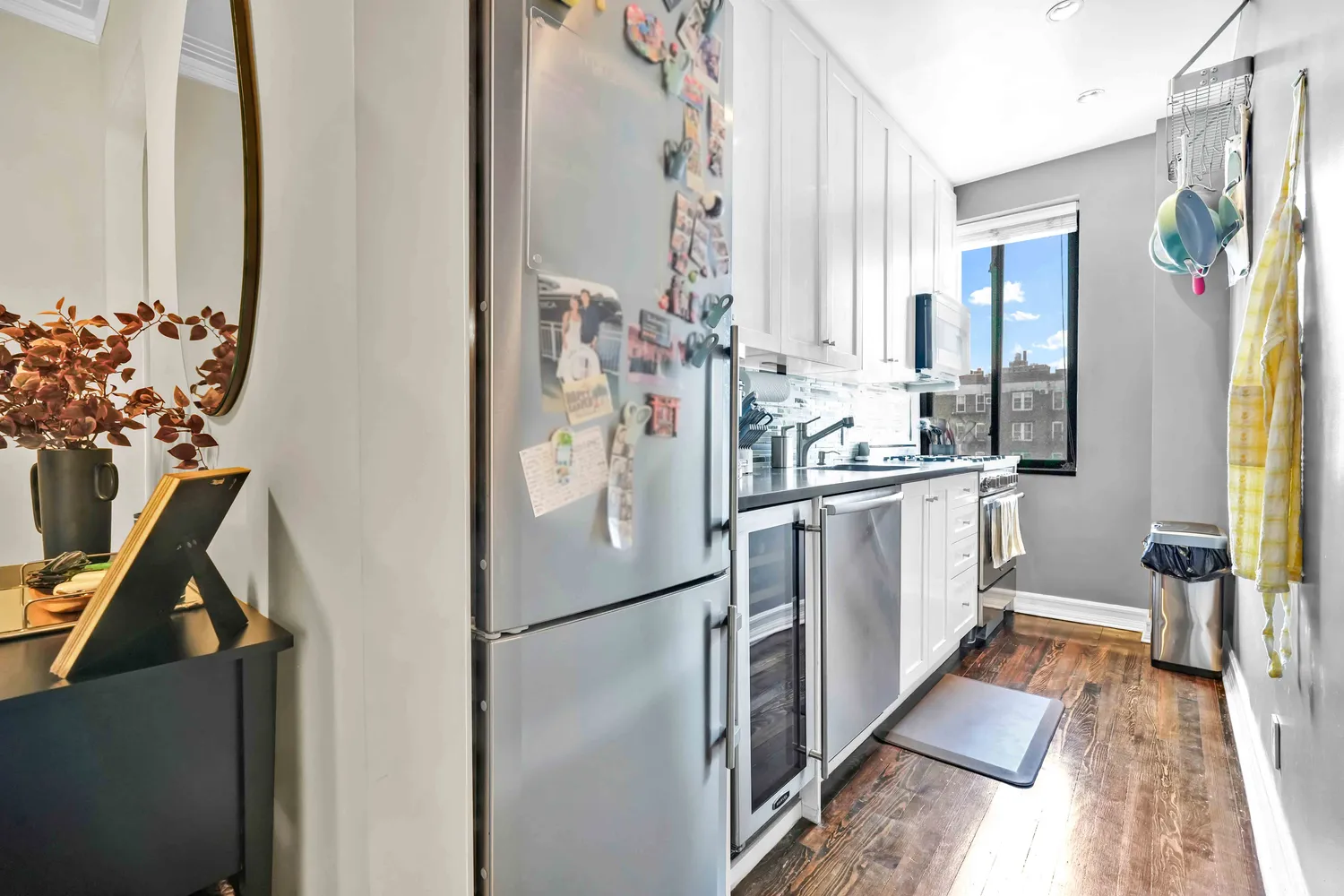 a kitchen with white cabinets and refrigerator