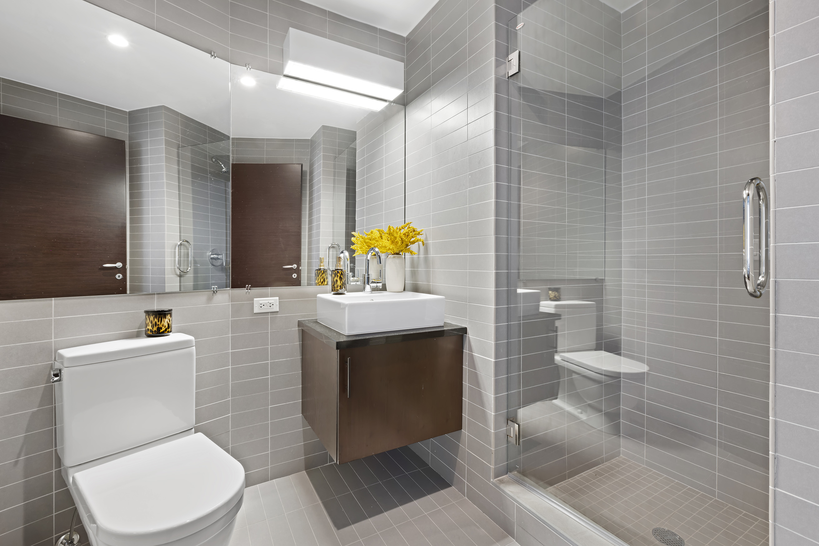 150 Myrtle Avenue, Unit 2506 Brooklyn, NY 11201 - Photo 15 of 16 a bathroom with a toilet a sink and mirror