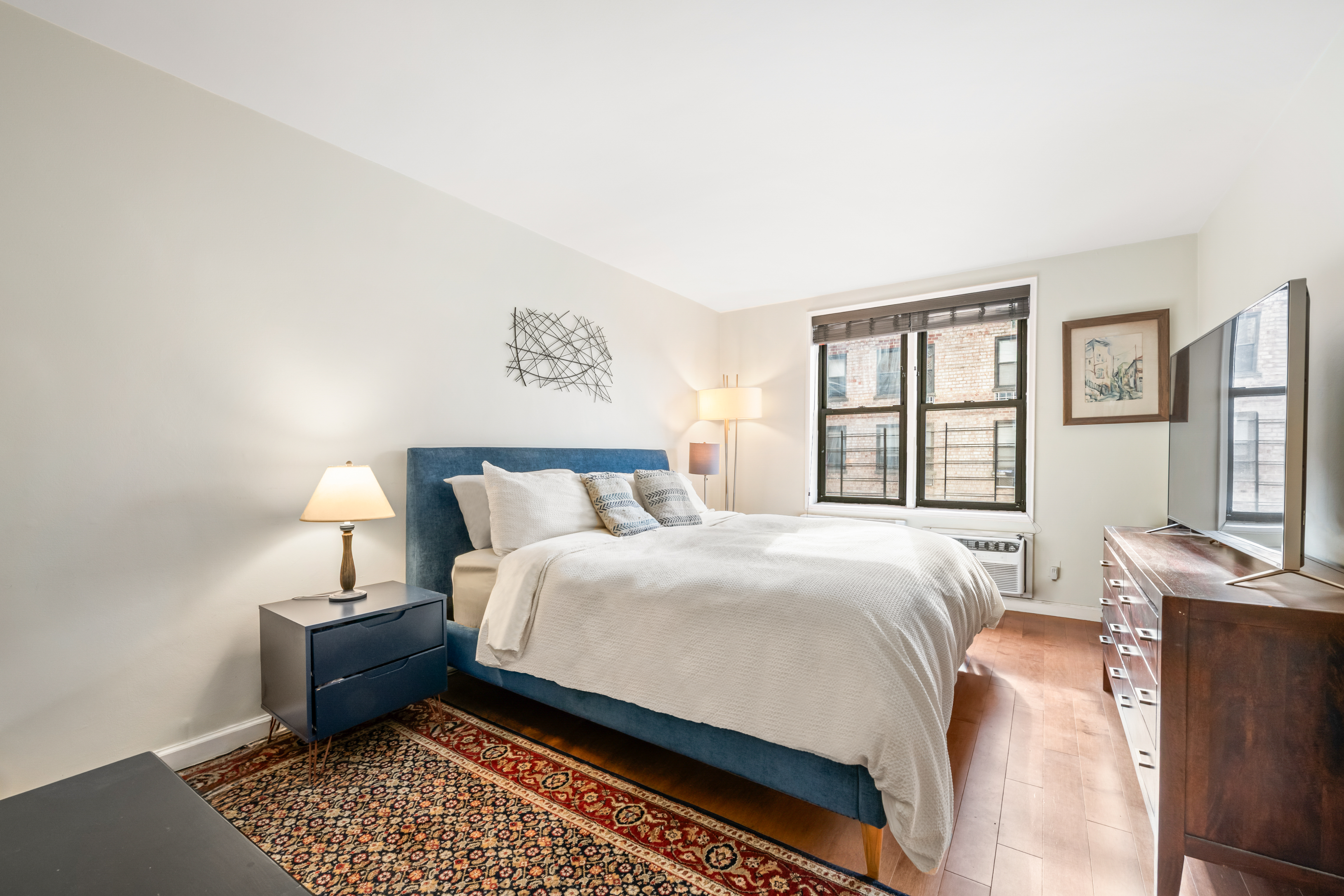 165 Christopher Street, Unit 5AA Manhattan, NY 10014 - Photo 5 of 9 a bed room with a bed and a window