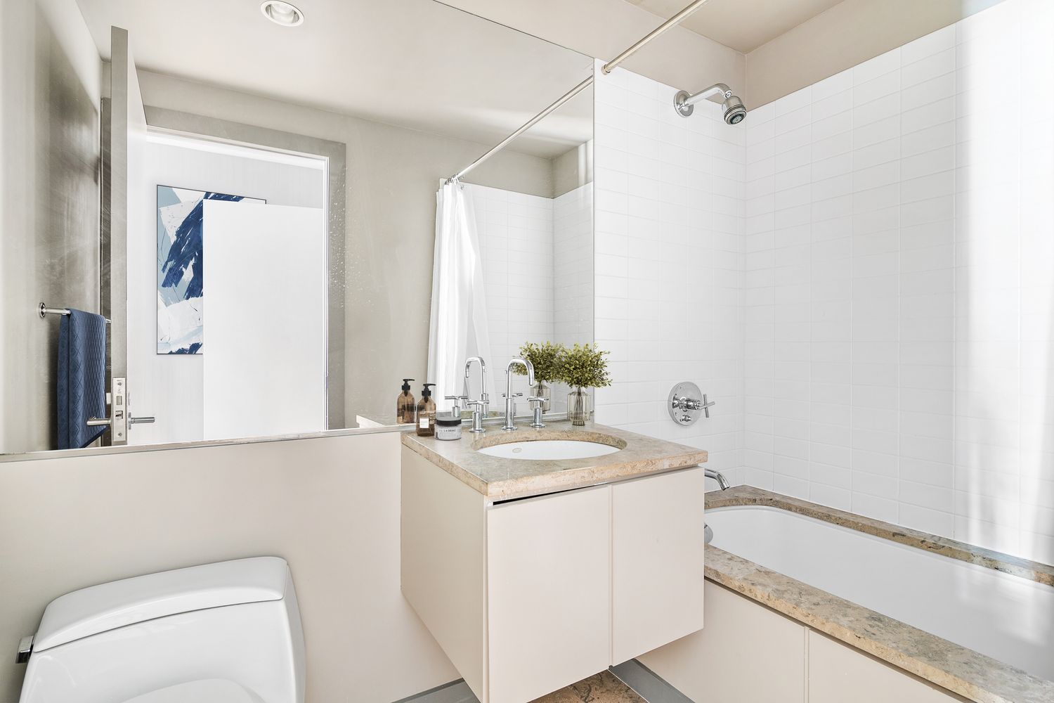 66 9th Avenue, Unit 4W Manhattan, NY 10011 - Photo 10 of 16 a bathroom with a sink a toilet and a mirror